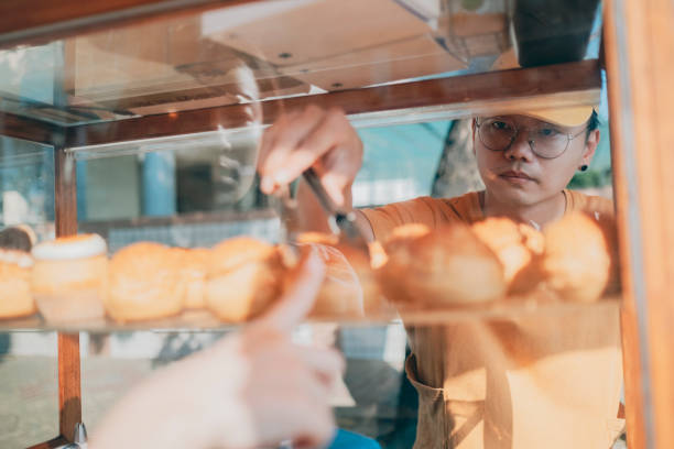 istock Guests buy cream puffs 1352373785