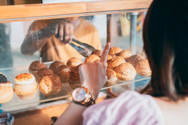 istock Guests buy cream puffs 1352373787