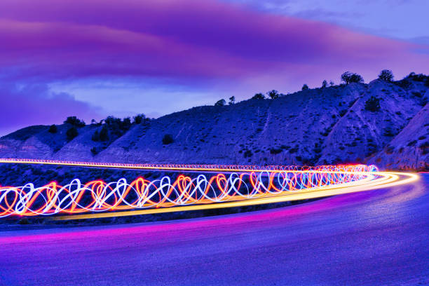 istock Creative Light Trails Along Dirt Road at Dusk 1352373799
