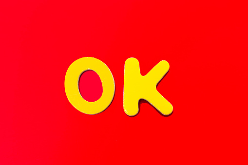OK: Word Written in Toy Letters, Vibrant Red Background