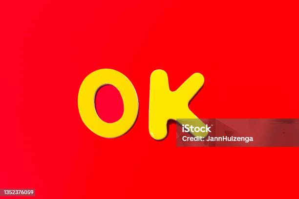 Ok Word Written In Toy Letters Vibrant Red Background Stock Photo - Download Image Now