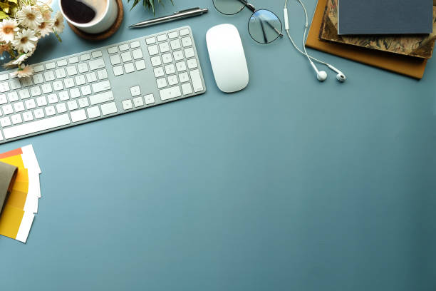 istock Above view cup of coffee, glasses, pencil holder and keyboard on creative designer workspace. 1352380949