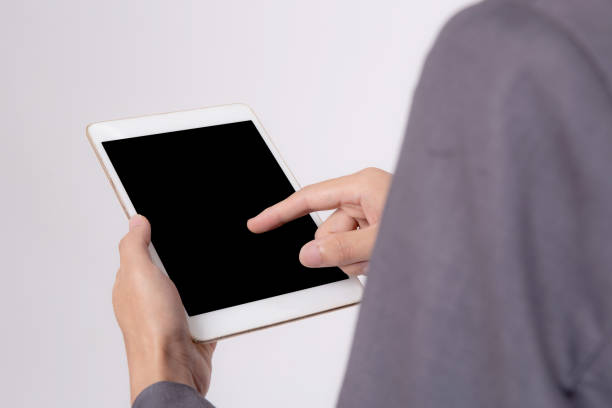 istock Closeup young asian business man showing and presenting tablet computer with blank screen with success isolated on white background, Hand of businessman using touchpad digital, communication concept. 1352381023