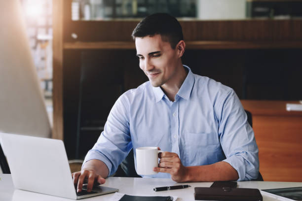 istock Male marketing managers drink coffee while working to reduce drowsiness before using computers, iPads, and marketing analysis papers. 1352383983
