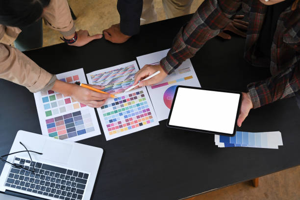 istock Above view team of creative designer working with color chart and brainstorming for new project. 1352385697