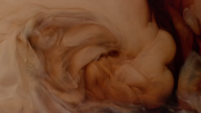Creamer swirling into coffee in slow motion.  Shot with Phantom Flex 4K camera.