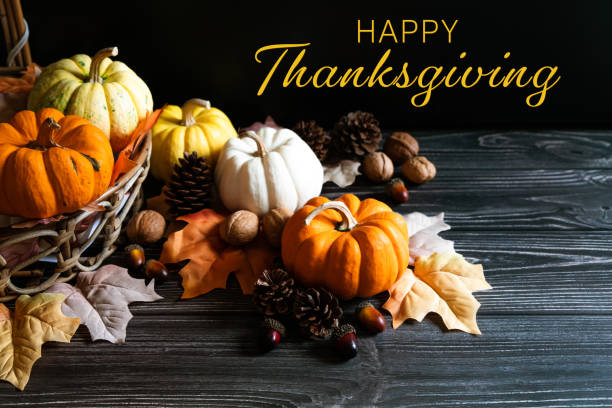 istock Happy Thanksgiving Day with pumpkin and nut on wooden table 1352393290