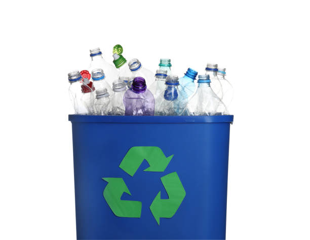 istock Many used bottles in trash bin isolated on white. Plastic recycling 1352396676
