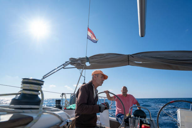istock A men on a sailboat looking at horizon while sailing, Croatia 1352397765