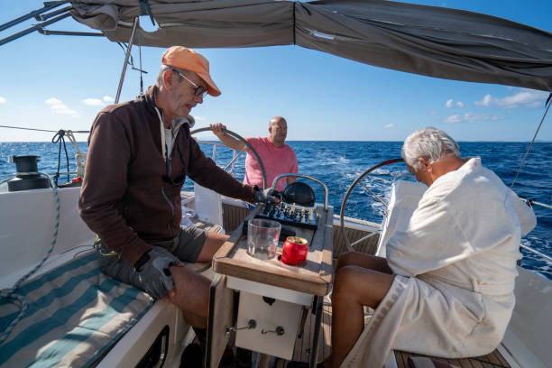 istock Three men on a sailboat, one driving while two are playing chess 1352397777