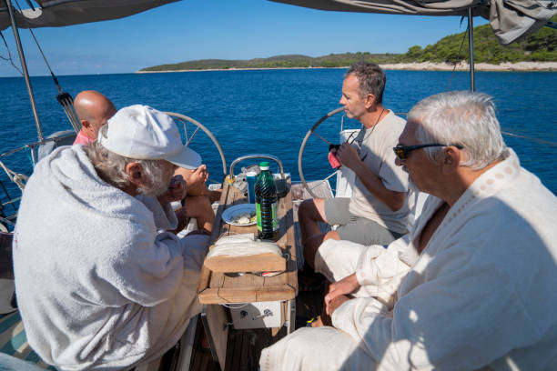 istock A four men on a sailboat enjoying food while sailing, Croatia 1352397810