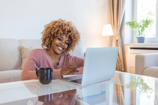 istock Woman using laptop while sitting at home. 1352398638