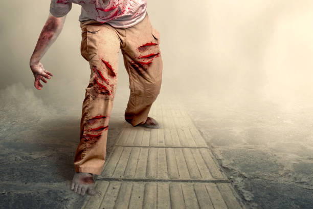istock Scary zombie with blood and wound on his body walking 1352398913