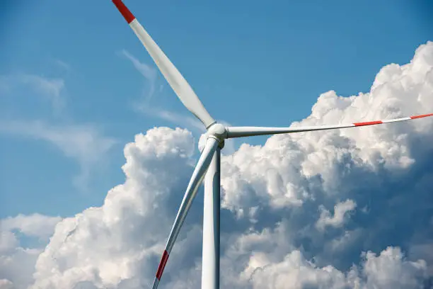 Photo of Wind Turbine against a Blue sky with Cumulus Clouds - Renewable Energy