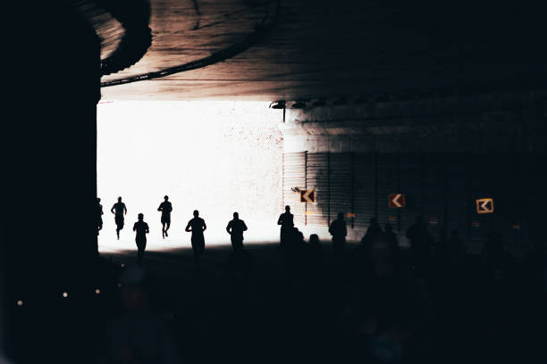 istock Silhouettes of a running people 1352401038