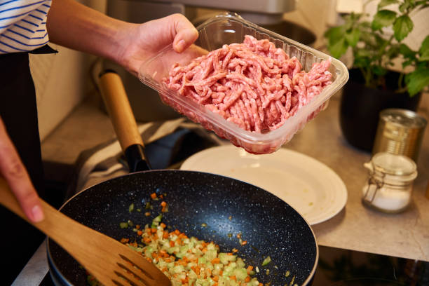 istock Woman cooking sauce bolognese in kitchen 1352402377