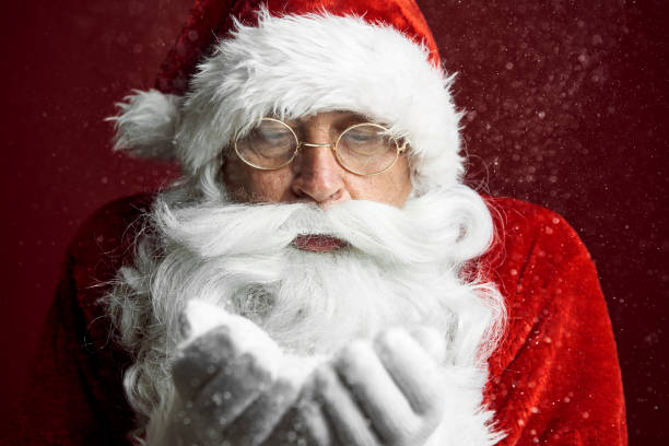 istock Santa Claus blowing the snow 1352402411