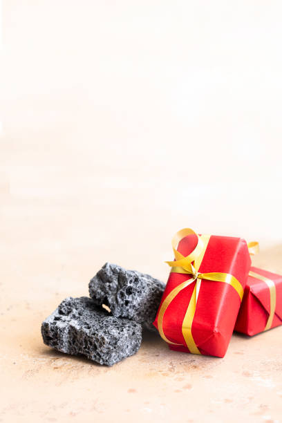 istock Sweet coal candy and red Christmas boxes, typical things that bring Tres Reyes Magos  ( Three Wise Men)  for Epiphany or Dia de Reyes Magos. 1352403126