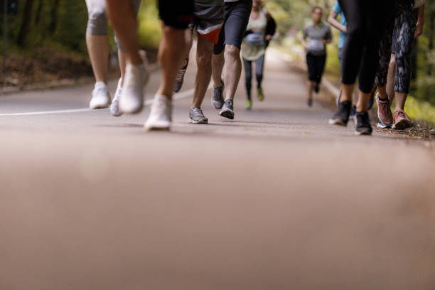 istock Unrecognizable athletes running a marathon on the road. 1352403336