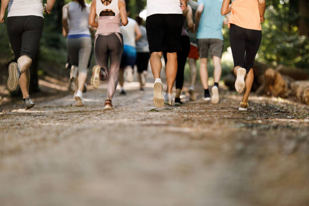 istock Rear view of unrecognizable athletes running a marathon. 1352403490