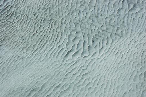 White sand texture at the beach for background