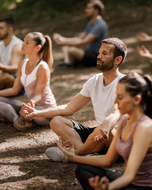 istock Group of athletes having Yoga class in nature. 1352403517