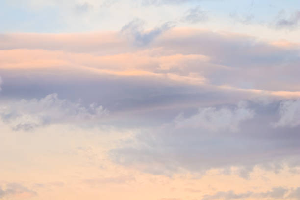 istock Background of blue sky with white and pink clouds in sunset 1352404065