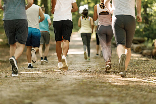 istock Back view of unrecognizable athletes running a marathon in nature. 1352404098