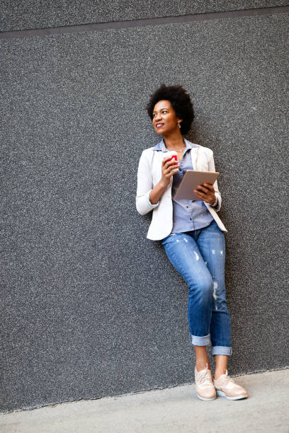 istock Business woman using tablet on coffee break in city 1352404269