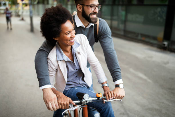 cheerful people going for a bike ride. happy couple having fun in the city. - cycling bicycle hipster urban scene imagens e fotografias de stock