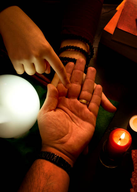 istock Concept of future reading. Pythoness reading the future in the hand of a man. 1352408554