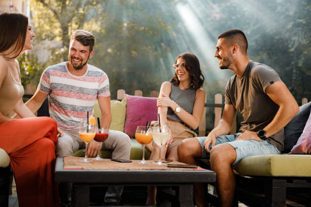 istock Young happy couples having a conversation in a cafe. 1352409149
