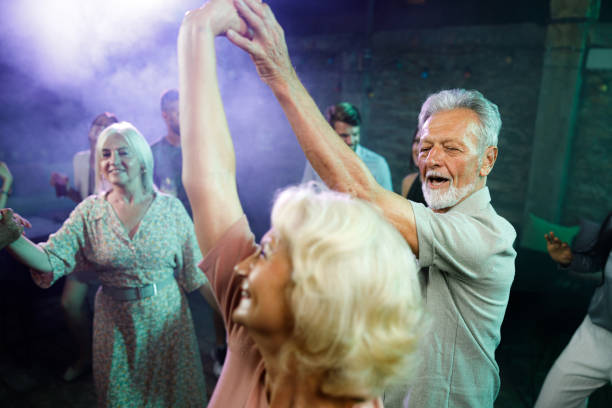 istock Happy mature couple enjoying while dancing in a disco. 1352410058