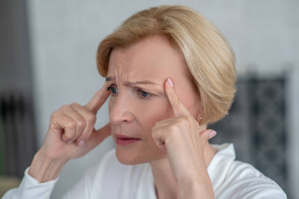 istock Midaged blone woman suffering from a headache 1352410297