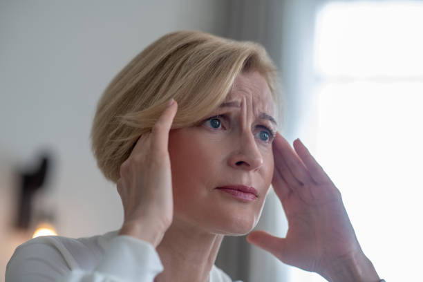 istock Midaged blone woman suffering from a headache 1352410301