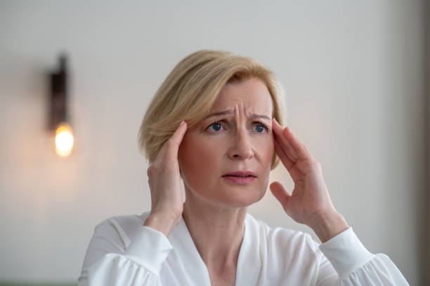 istock Midaged blone woman suffering from a headache 1352410308