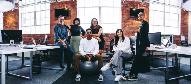 Modern businesspeople smiling cheerfully in an office
