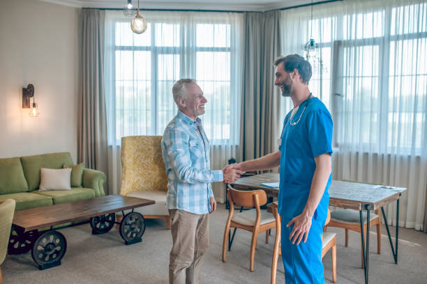 istock Joyous man shaking his physician by the hand 1352410578