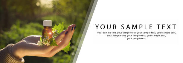 Hand with aroma oil in bottle. Bach flower essence and blooming nettle. Website banner, copy space. Alternative Medicine concept.