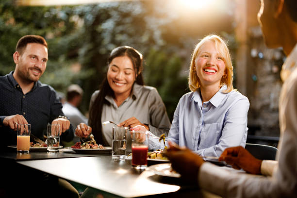 istock Happy colleagues talking while enjoying in lunch at a restaurant. 1352411967
