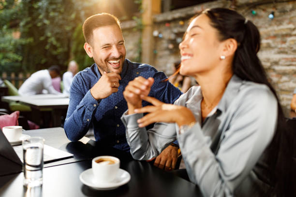 istock Happy business colleagues talking on a break in a cafe. 1352412033
