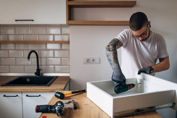istock A carpenter uses an electric screwdriver to renovate the kitchen 1352414735