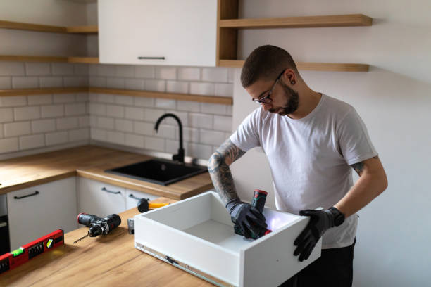 istock A focused carpenter arranges the kitchen in his new apartment. He is working on installing a drawer. 1352414788