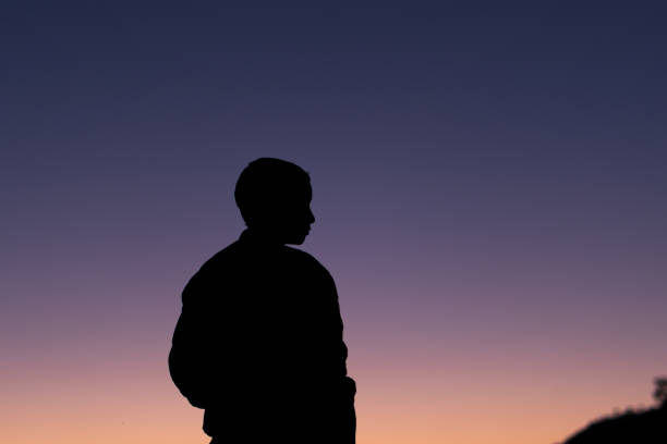 istock silhouette of a young boy during sunset 1352414901