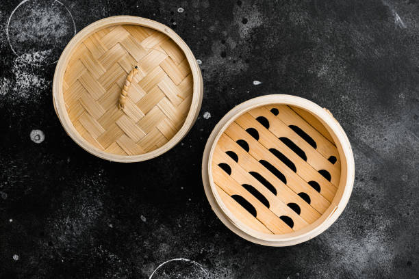 Empty Bamboo Steamer set, with copy space for text or food, with copy space for text or food, top view flat lay, on black dark stone table background