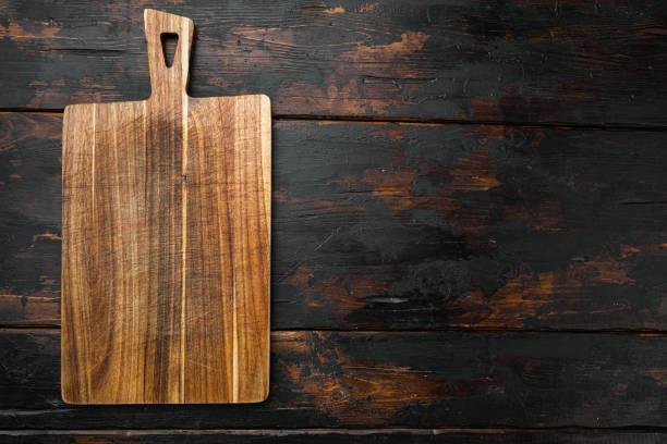 istock Bamboo cutting board empty for empty for copy space for text or food, top view flat lay , on old dark  wooden table background 1352416977