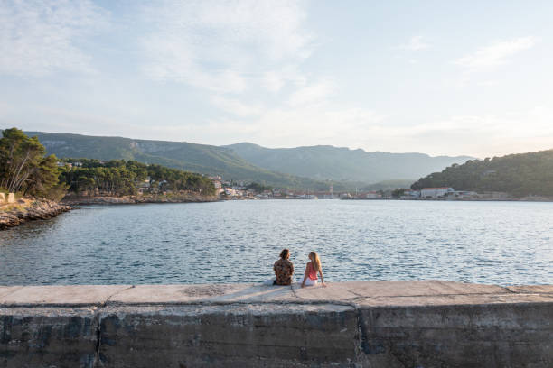 Rear view of the two adults looking towards Croatian old town.Croatia, travel in Eastern Europe concept