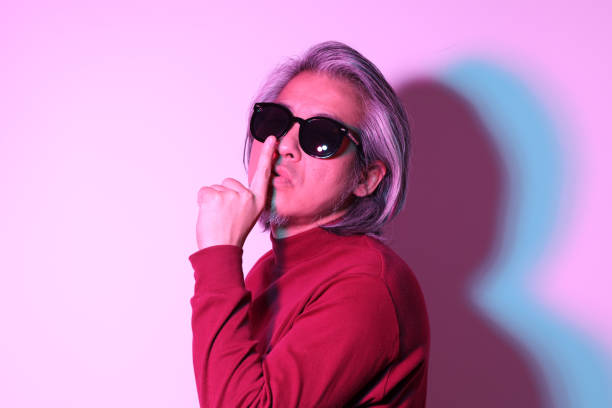 The cool senior Asian man in the gel color light photography.