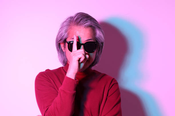 The cool senior Asian man in the gel color light photography.