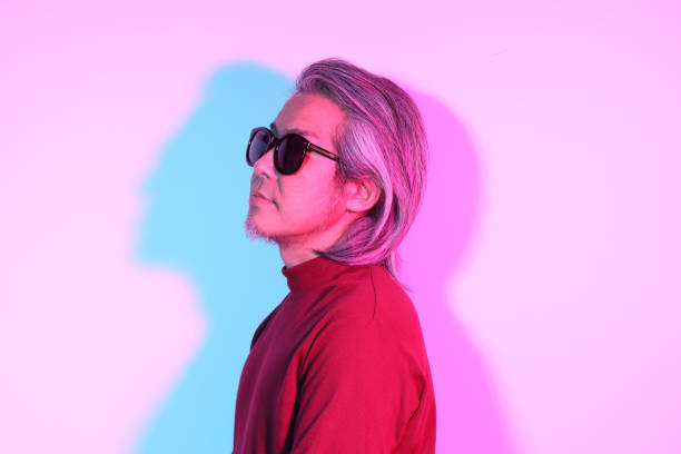 The cool senior Asian man in the gel color light photography.